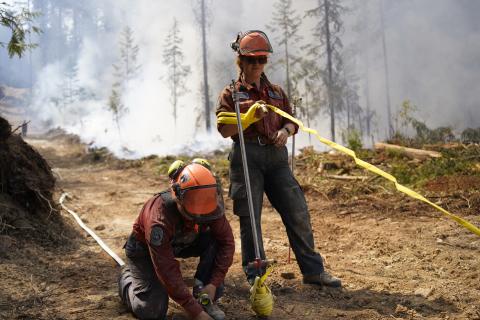 BC Wildfire crew members running hose