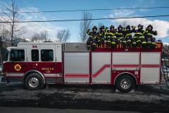 fire truck with firefighters sitting on top